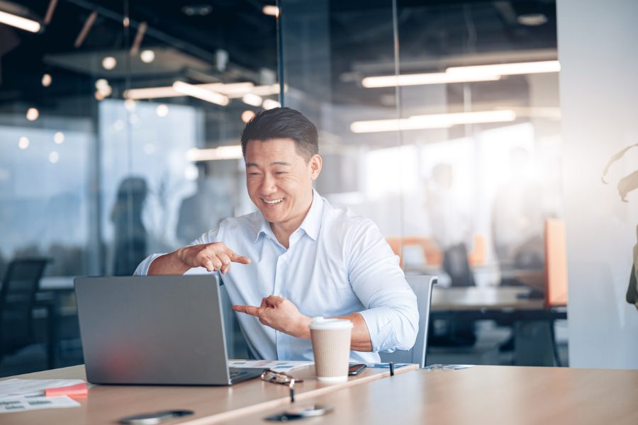 A photo of a man on a zoom call appearing to use sign language